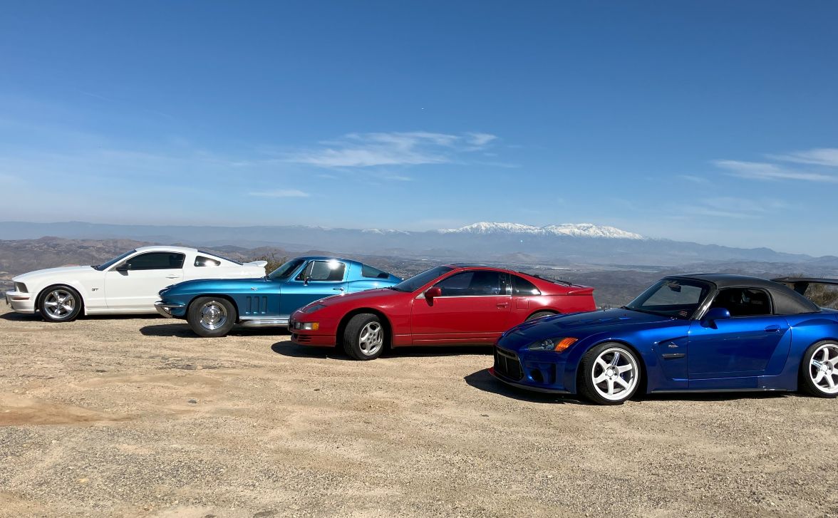 Sports cars staged against mountain views